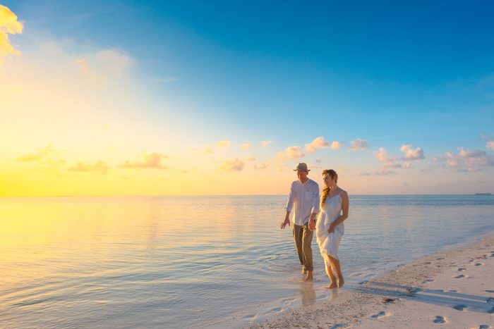 Newlywed Couple Walking on the Beach in the Maldives for Their Honeymoon