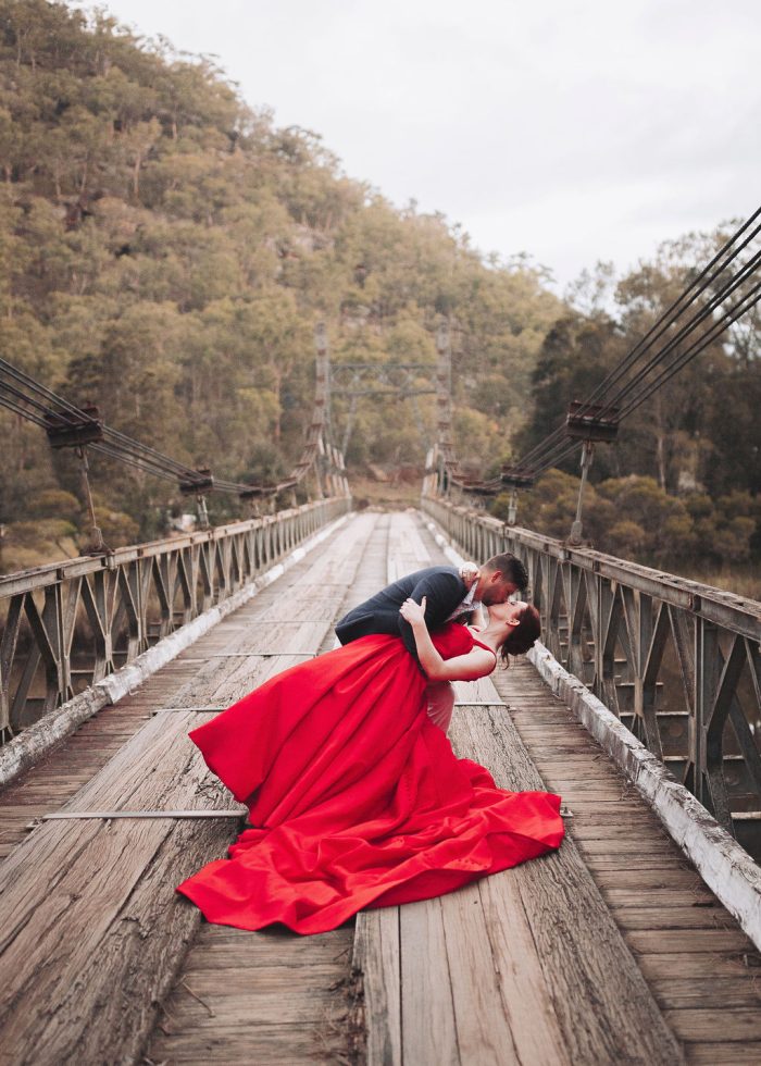 Groom Dipping and Kissing Bride Wearing Alera Wedding Dress by Maggie Sottero