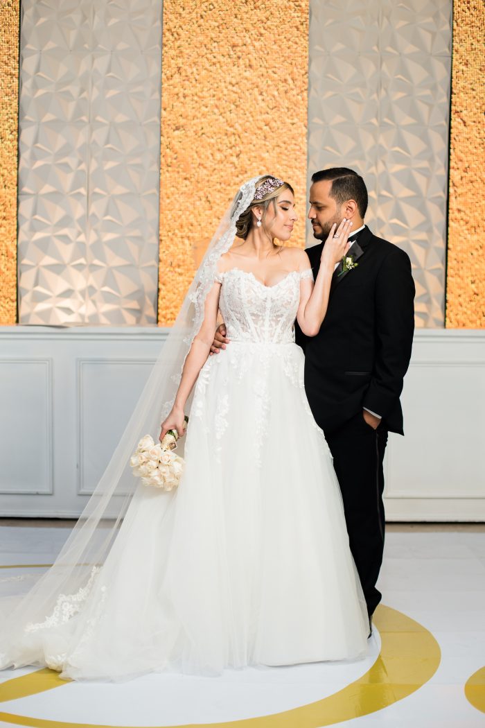 Bride Looking At Groom Wearing Harlem Wedding Dress by Maggie Sottero