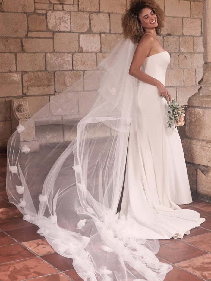 Bride Wearing Minimalist Sheath Wedding Dress with Long Tulle Wedding Veil Called Bayler by Maggie Sottero