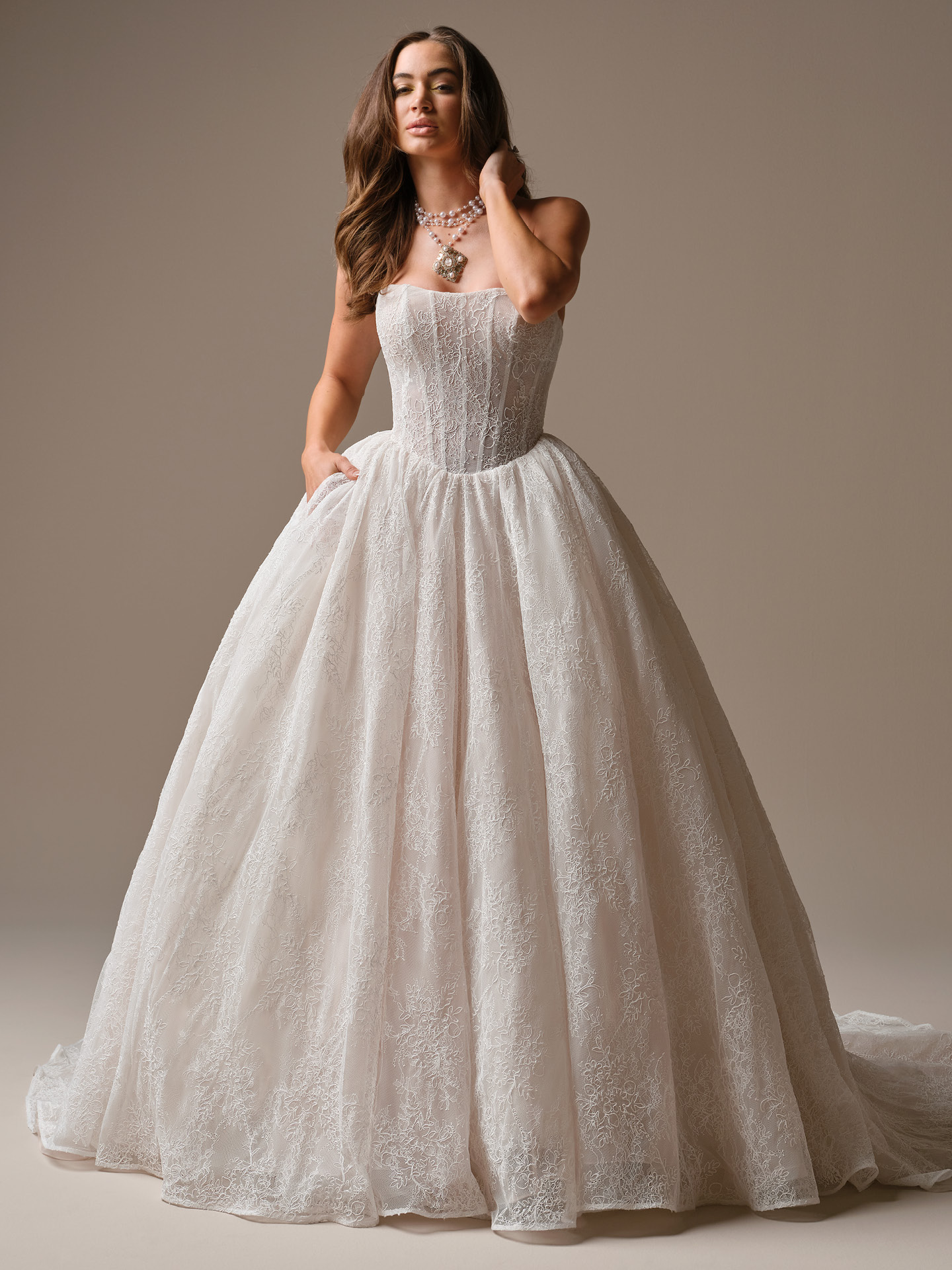 Strapless lace princess ballgown wedding dress with structured corset bodice, sweetheart neckline, and full lace skirt with chapel train.