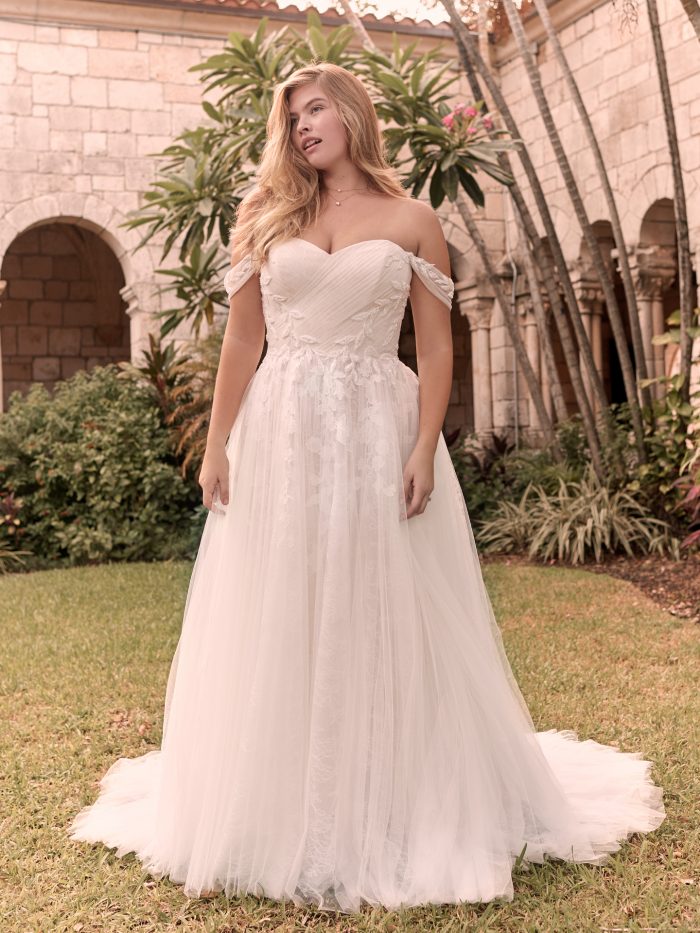 Model Wearing Affordable Off-the-Shoulder Sleeve Wedding Dress Called Floral by Rebecca Ingram