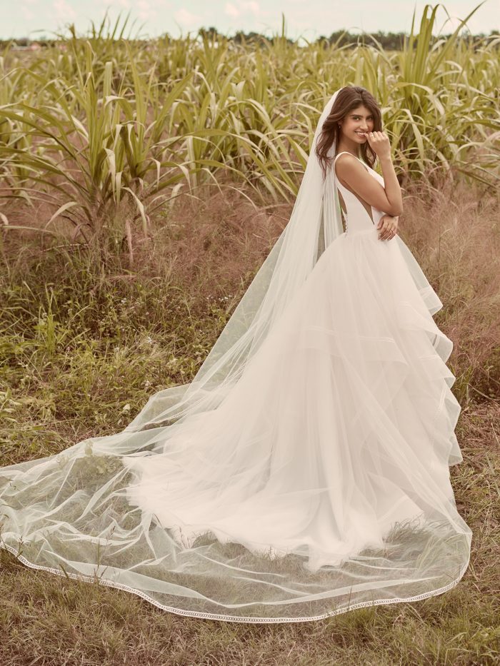 Model Wearing Minimalist Dreamy Ball Gown Wedding Dress with Veil Called Rosemary by Rebecca Ingram