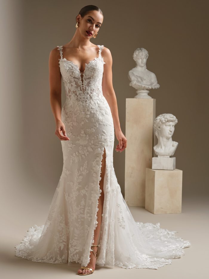 Sexy lace fit-and-flare wedding dress with floral lace appliqués, illusion plunge neckline, thin straps, and dramatic side slit.