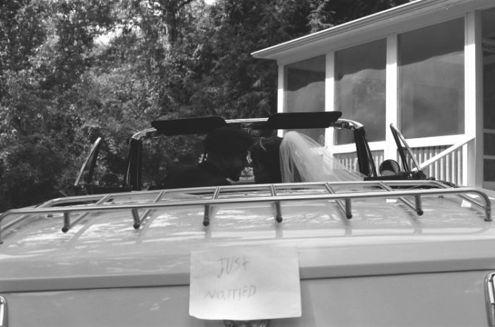 Bride and Groom Driving Away in a Getaway Car