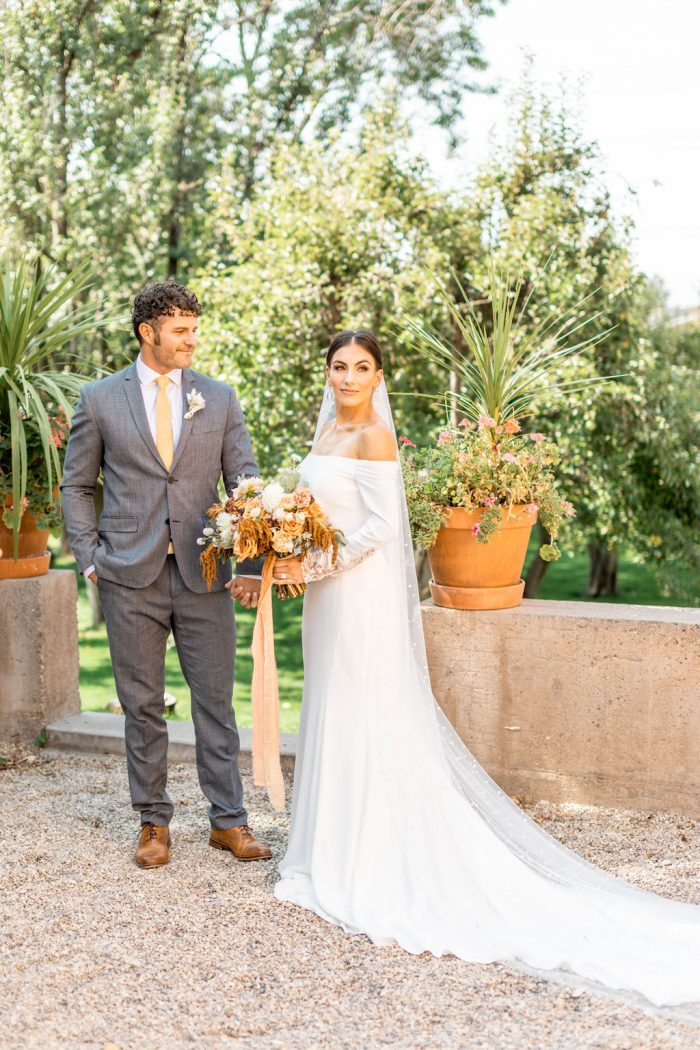 Groom at Italian Wedding with Bride Wearing Off-the-Shoulder Crepe Wedding Dress Called Admina by Sottero and Midgley