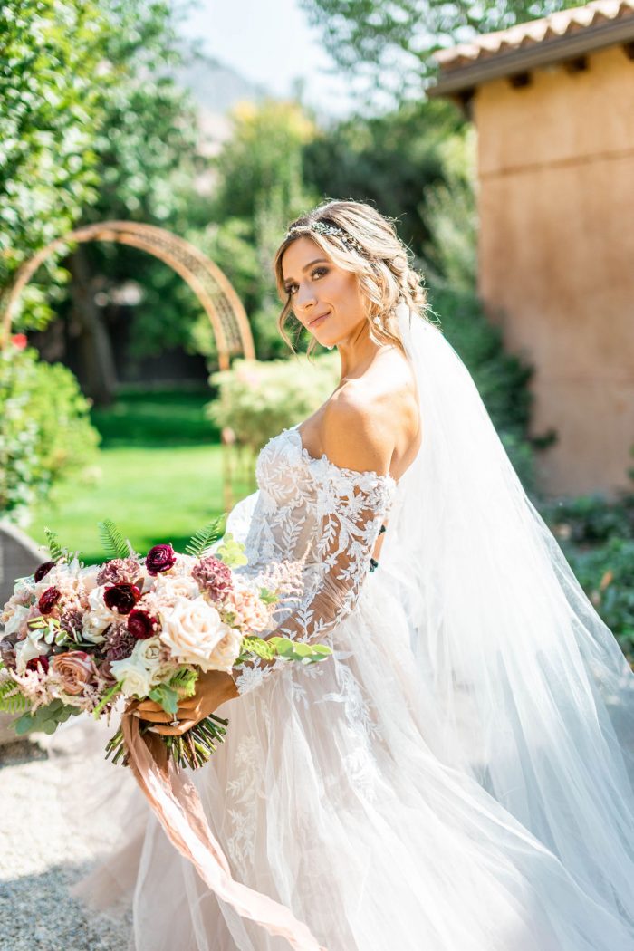 Model Wearing Floral Off-the-Shoulder Sleeve Ball Gown Wedding Dress Called Orlanda by Maggie Sottero