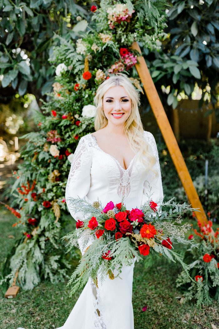 Real Bride Wearing Luxe Crepe Bell Sleeve Wedding Dress Called Armante by Sottero and Midgley