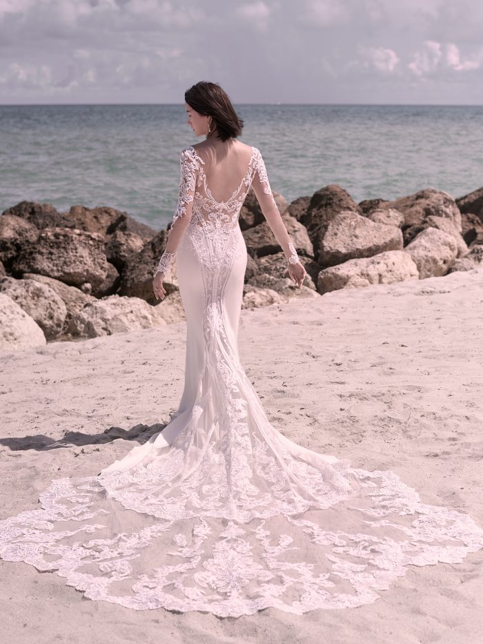 Bride on Beach Wearing Illusion Lace Sheath Wedding Gown Called Cambridge Dawn by Sottero and Midgley