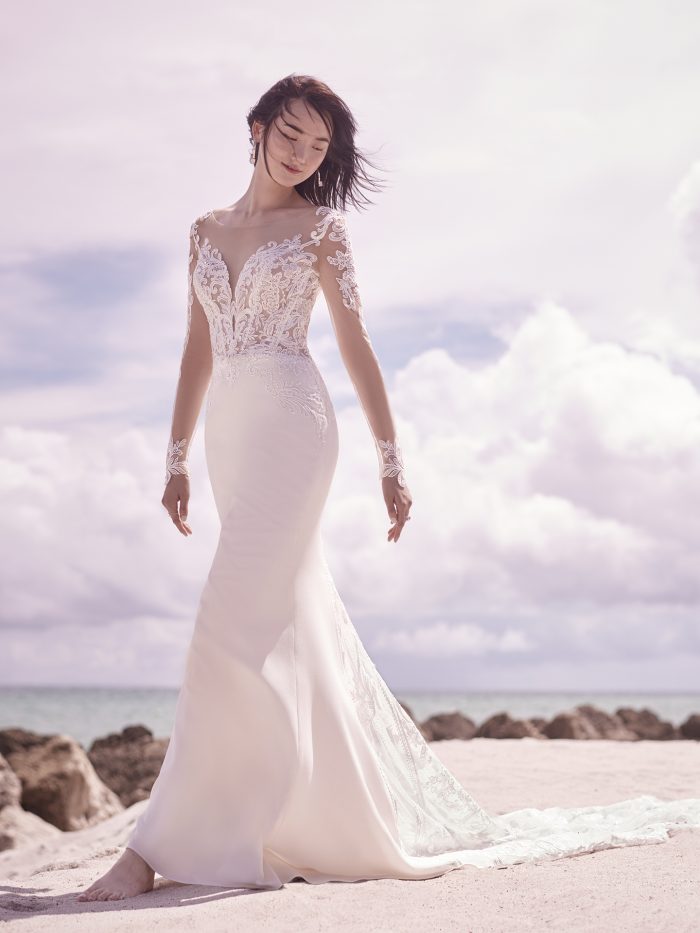 Bride on Beach Wearing Illusion Lace Sheath Wedding Gown Called Cambridge Dawn by Sottero and Midgley