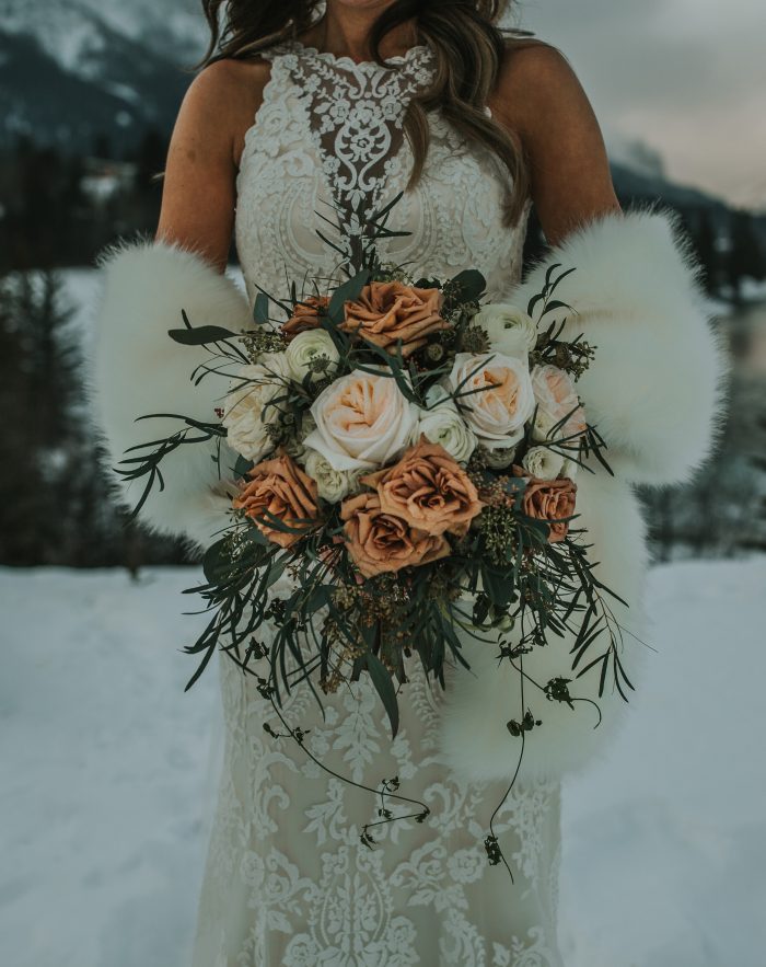 Real Bride in the Winter Holding Bridal Bouquet With White and Toffee Roses