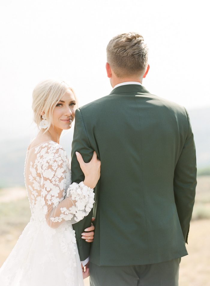 Groom with Bride Wearing Custom Maggie Sottero Wedding Dress with Illusion Bishop Sleeves
