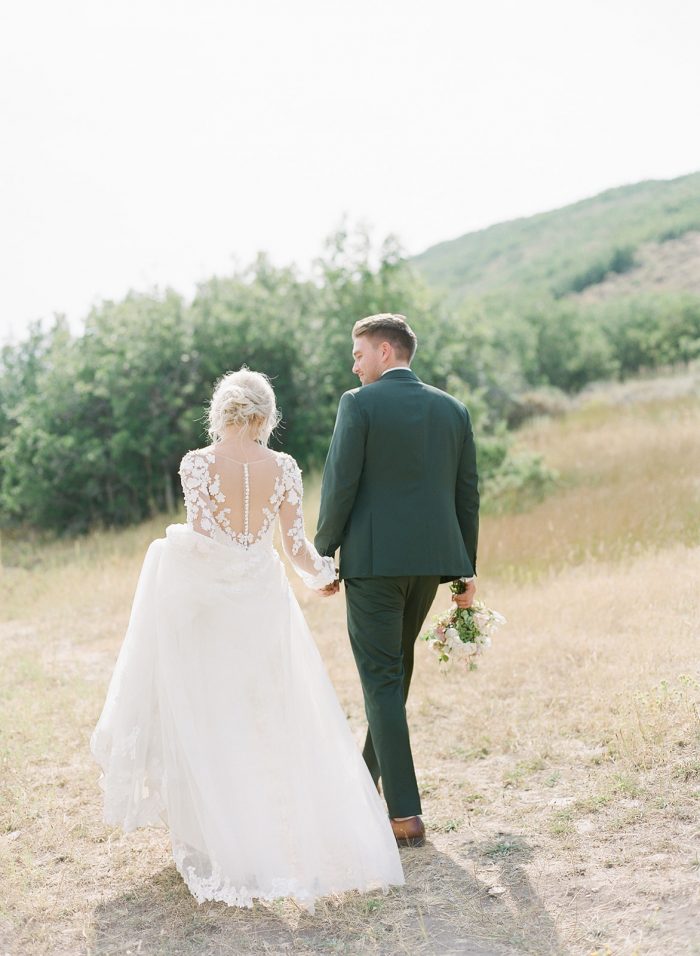 Groom with Real Bride Wearing 3-D Floral Lace Sheath Wedding Dress with Overskirt by Maggie Sottero