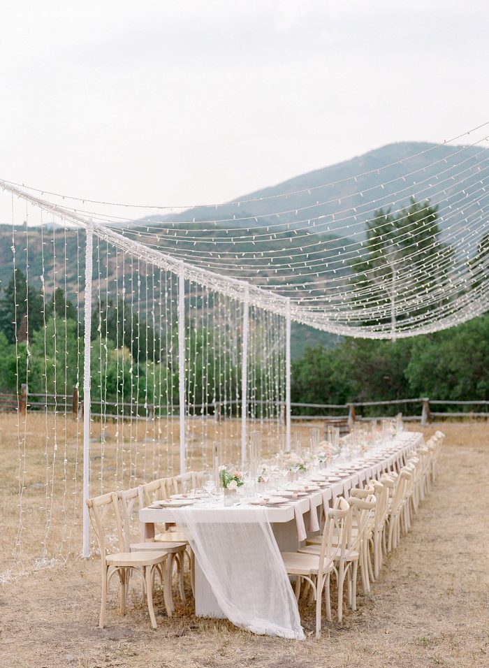 Rustic Table Settings with Hanging Lights at Summer Wedding in the Utah Mountains