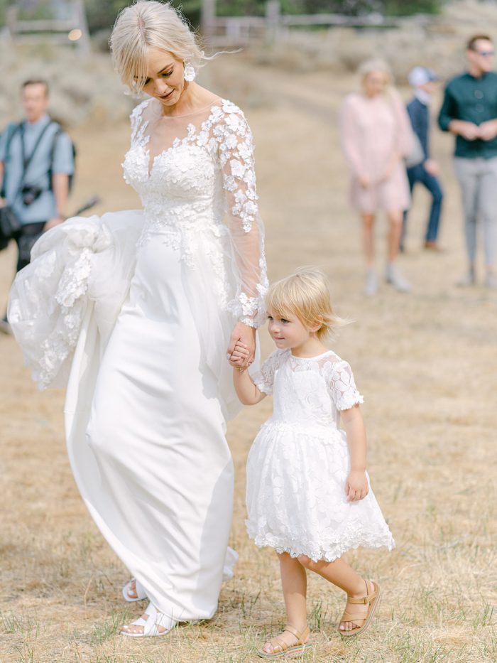 Bride Wearing 3-D Floral Sheath Bridal Gown Called Arta by Maggie Sottero and Walking with Her Daughter