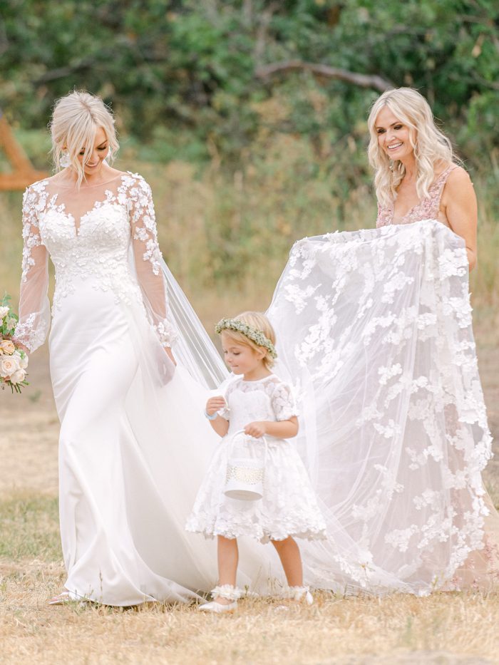 Bride Wearing 3-D Floral Sheath Bridal Gown Called Arta by Maggie Sottero and Walking with Her Daughter