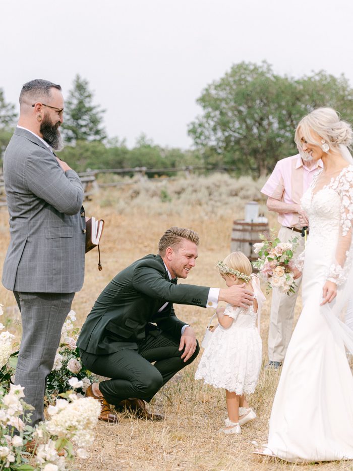 Groom Hugging Bride's Daughter During Intimate Wedding Ceremony