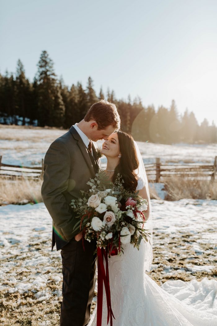 Groom with Real Bride Wearing Off-the-Shoulder Sleeve Lace Wedding Dress Called Sabra by Maggie Sottero