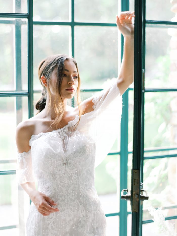 Bride Wearing Shimmery Off-the-Shoulder Bohemian Wedding Dress Called Conrad by Sottero and Midgley