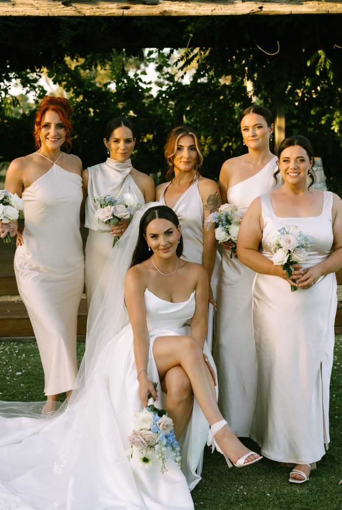 Bride wearing Aspen by Sottero and Midgley with her bridesmaids in champagne bridesmaid dresses