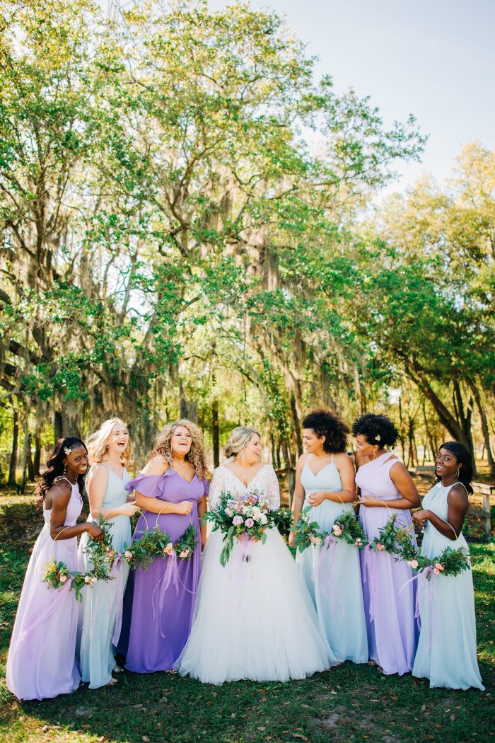 Bride With Bridesmaids Wearing Pastel Purple and Blue Bridesmaid Dresses for Spring Wedding