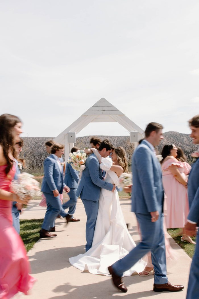 Bride wearing Mitchell by Maggie Sottero with her friends in blush bridesmaid dresses