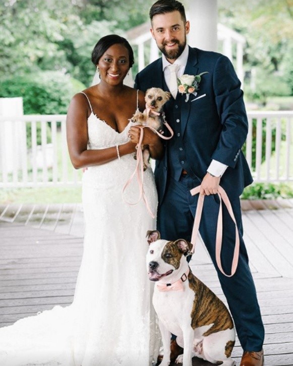 Bride and Groom holding dogs with bride wearing Nola Lace Sheath wedding gown by Maggie Sottero