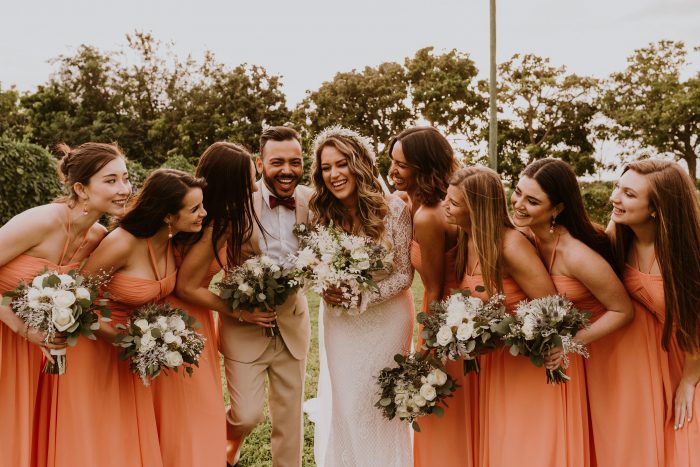Bride Laughing with Her Bridesmaids Wearing Peach Bridesmaid Dress Ideas