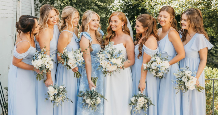 Bride surrounded by her friends wearing blue bridesmaid dresses