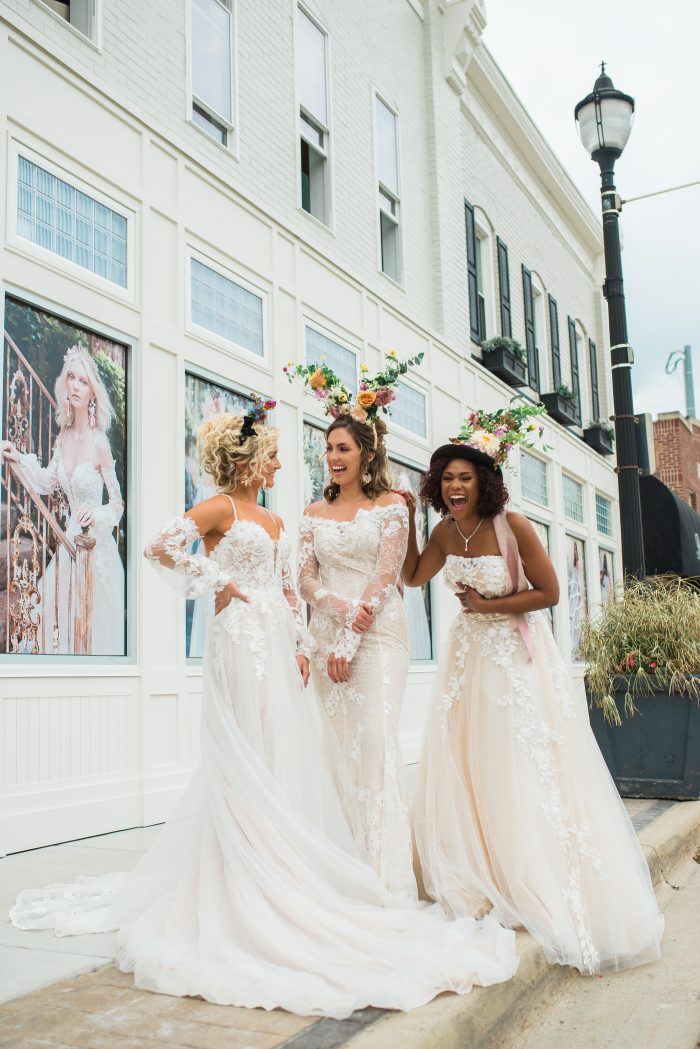 Three models wearing fun floral headpieces while wearing Maggie Sottero wedding dresses