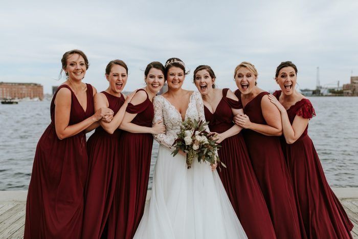 Bride In Long Sleeve Wedding Dress Called Mallory Dawn With Bridesmaids In Burgandy