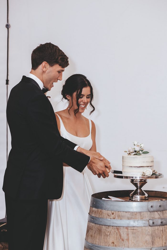 Bride and Groom Cutting Chocolate Wedding Cake at Vineyard Wedding