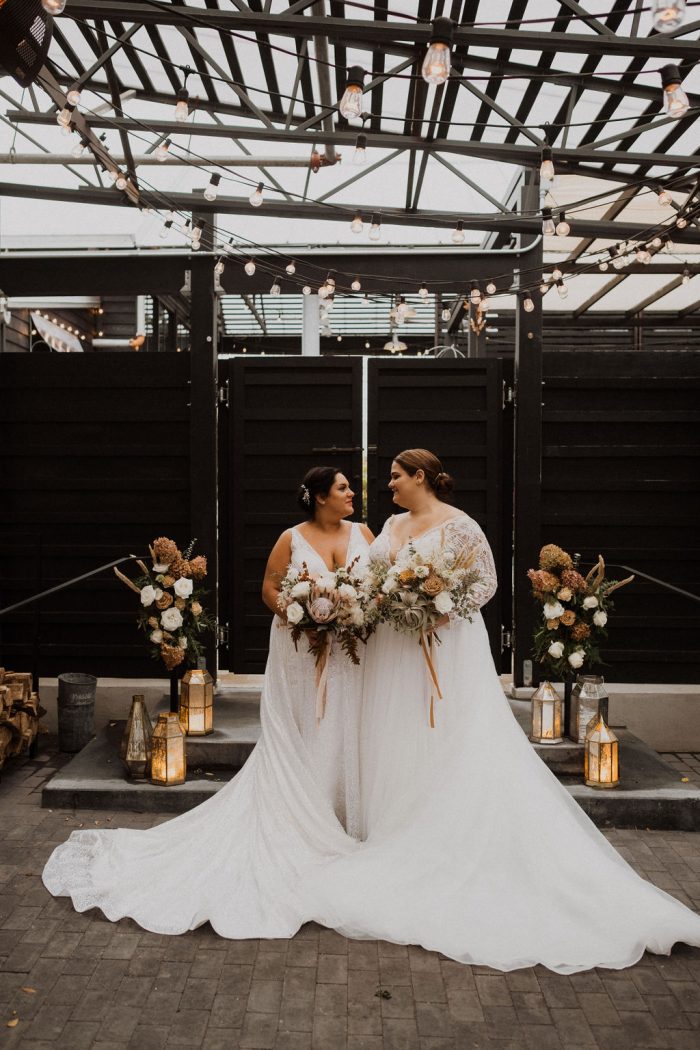 LGBTQ Brides Holding Matching Bouquets While One Bride Wears Maggie Sottero Wedding Dress Mallory Dawn