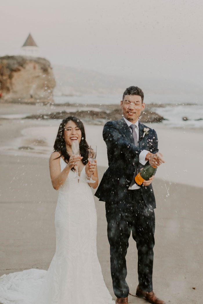 Bride and Groom Popping Champagne Bottle After Beach Elopement Ceremony