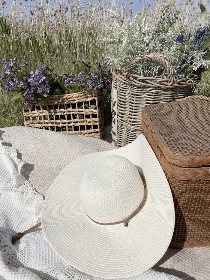 Cottagecore Picnic with Sunhat and Flowers in Field