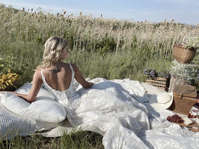 Bride Laying Down at Picnic and Wearing Cottagecore Wedding Dress Called Sawyer by Sottero and Midgley