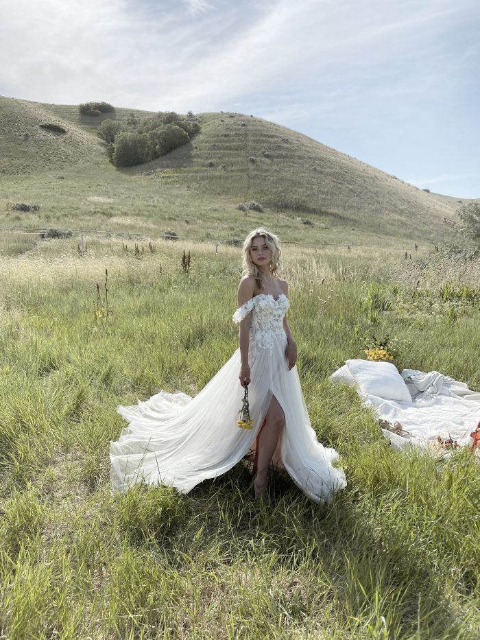 Bride in Field Wearing 3-D Floral Cottagecore Wedding Gown Called Mirra by Maggie Sottero