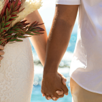 Bride and Groom Holding Hands with Bridal Bouquet