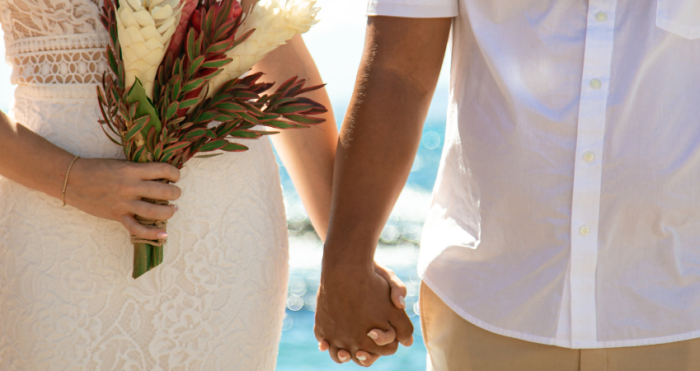Bride and Groom Holding Hands with Bridal Bouquet