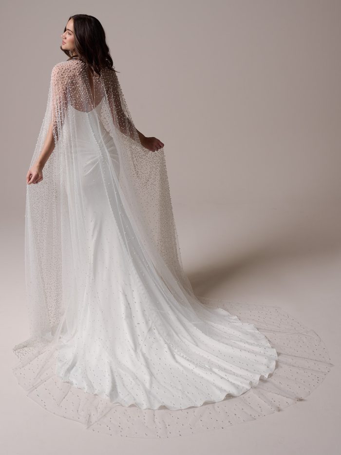 Bride wearing Sottero and Midgley Forsythia cape accessory , a pearl-embellished sheer bridal cape styled over a strapless wedding dress, shown from front and back views with flowing train.