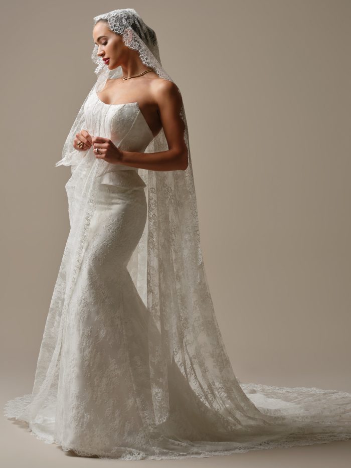 Sottero and Midgley Lassen lace cathedral veil paired with a strapless lace fit-and-flare wedding dress, side view.