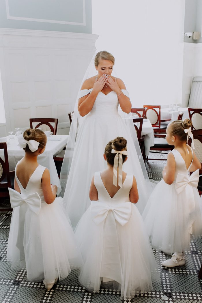 Bride wearing Anniston by Maggie Sottero and showing her flower girls