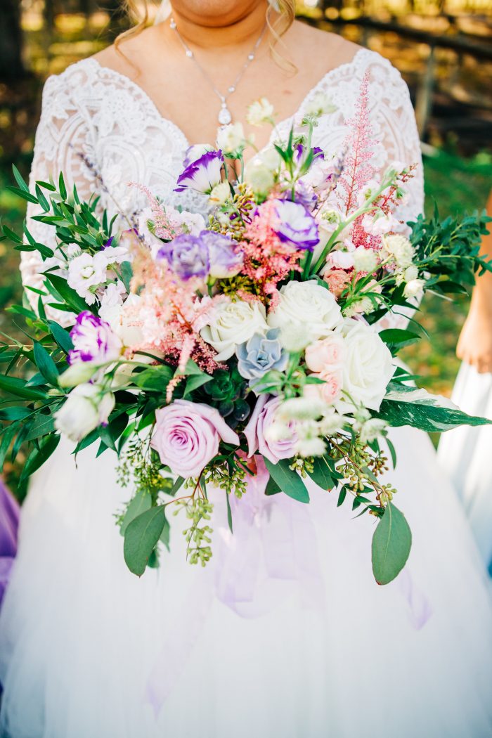 Bride Holding Bouquet Featuring Lavender and Blue Summer Wedding Color Palette
