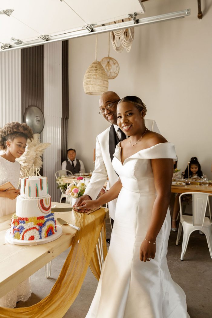 Photo Of Rainbow Wedding Cake With Bride Wearing Josie By Rebecca Ingram