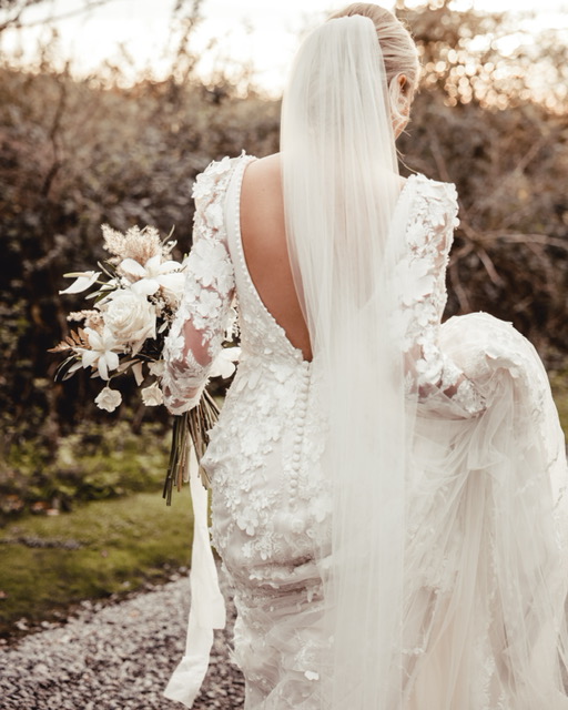 Bride In Zodiac Wedding Dress Called Cruz By Sottero And Midgley With 3D Flowers And Fit And Flare