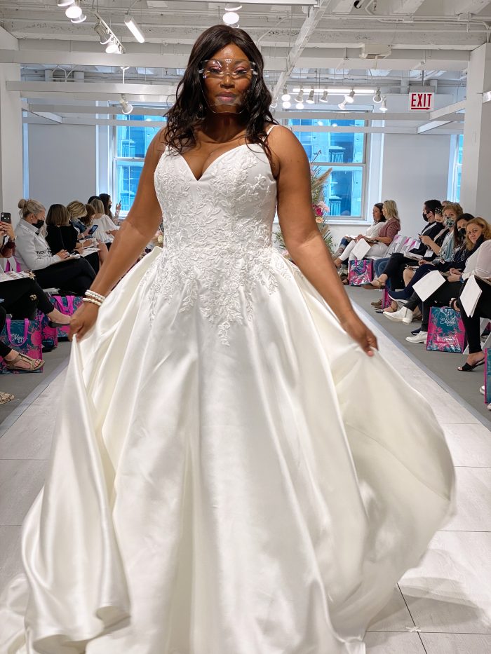 Model Walking Down the Runway at Chicago Bridal Market Wearing Plus Size Wedding Dress Called Iona by Rebecca Ingram