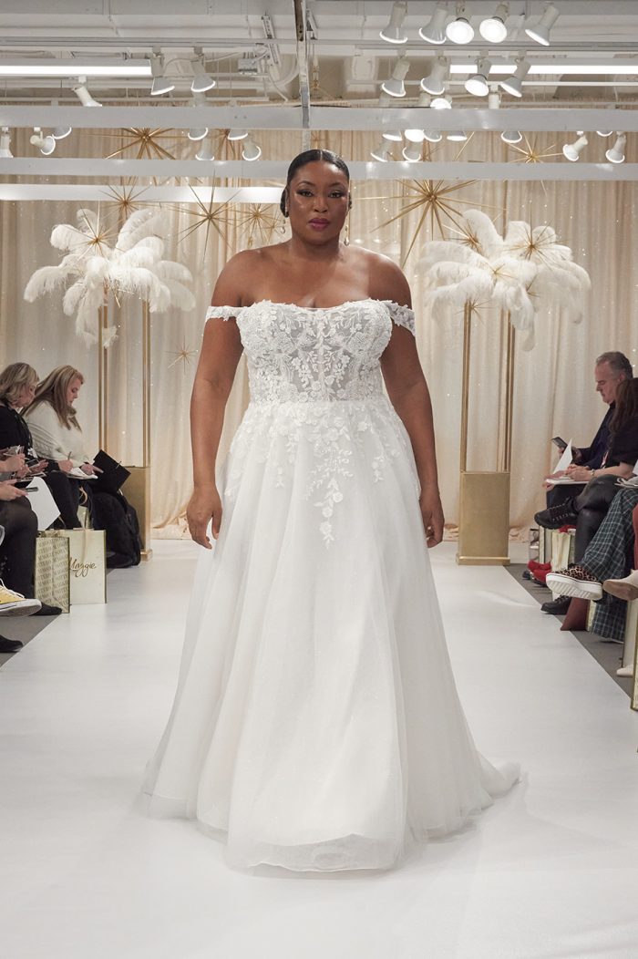 Model Liris Crosse Wearing Off-The-Shoulder Wedding Gown Called Ainsleigh By Rebecca Ingram