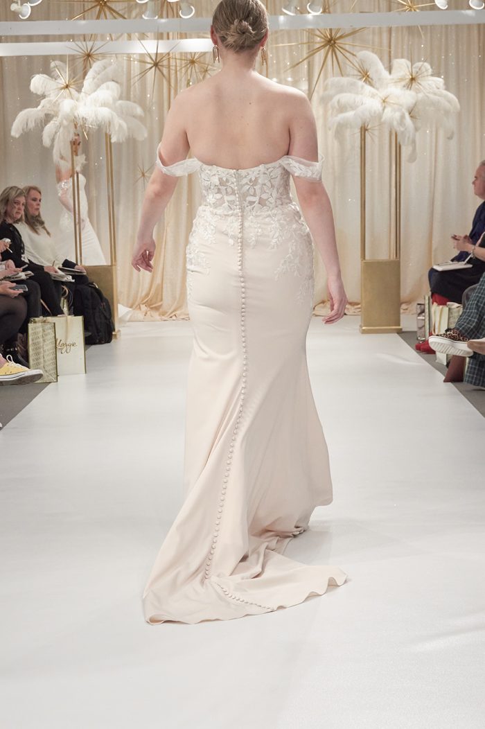 Model Wearing Sheath Runway Wedding Dress Called Lily By Rebecca Ingram