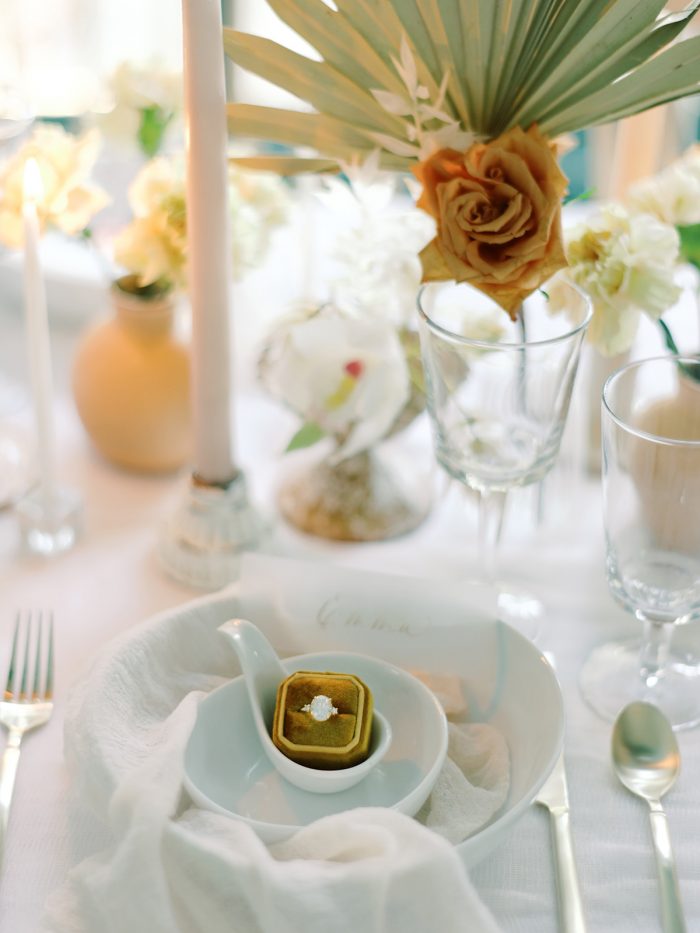 Engagement Ring Placed In Dishware Set And Flowers