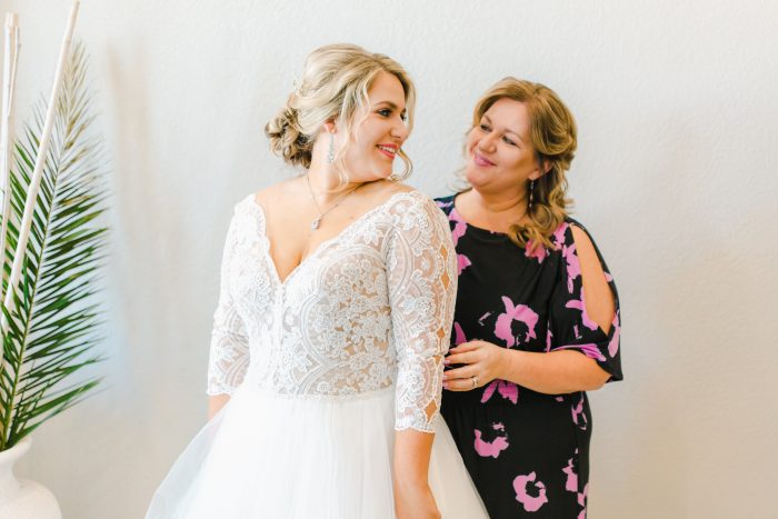 Bride Smiling At Her Mother While Getting Dressed